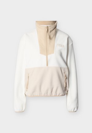 Veste en polaire à demi-fermeture éclair en crème et beige avec poches latérales zippées, poignets élastiques et col montant, logo Columbia sur la poitrine.