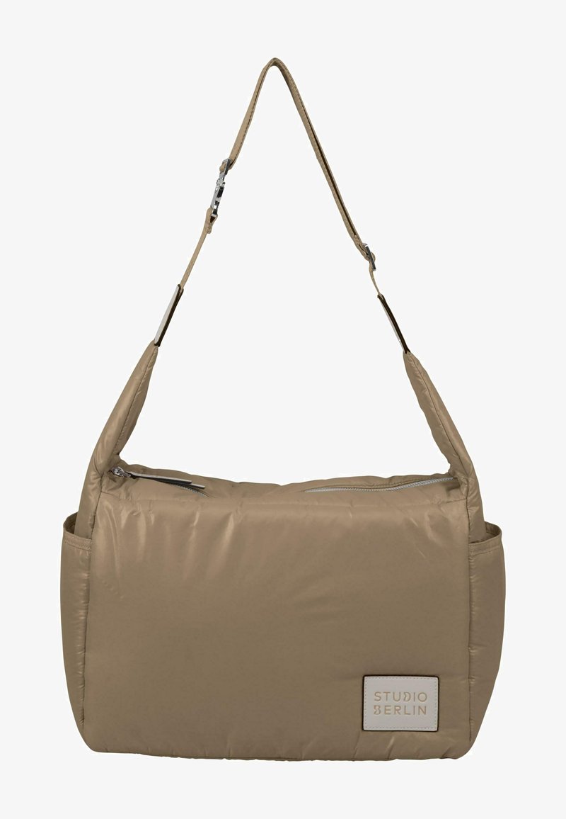 Tan puffer shoulder bag with a smooth, shiny texture; features a long adjustable strap and a zippered top; includes a branded tag.
