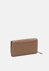 Brown leather wallet with a textured surface, rectangular shape, and zip closure. Features clean stitching and a minimalist design.