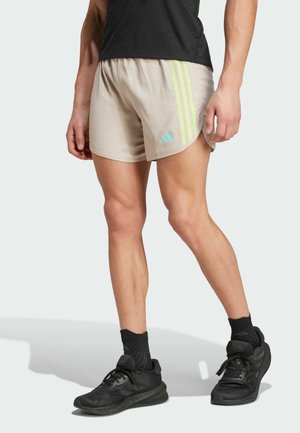 adidas Performance, OWN THE RUN 3-STRIPES - Pantalón corto de deporte - beige pulse lime