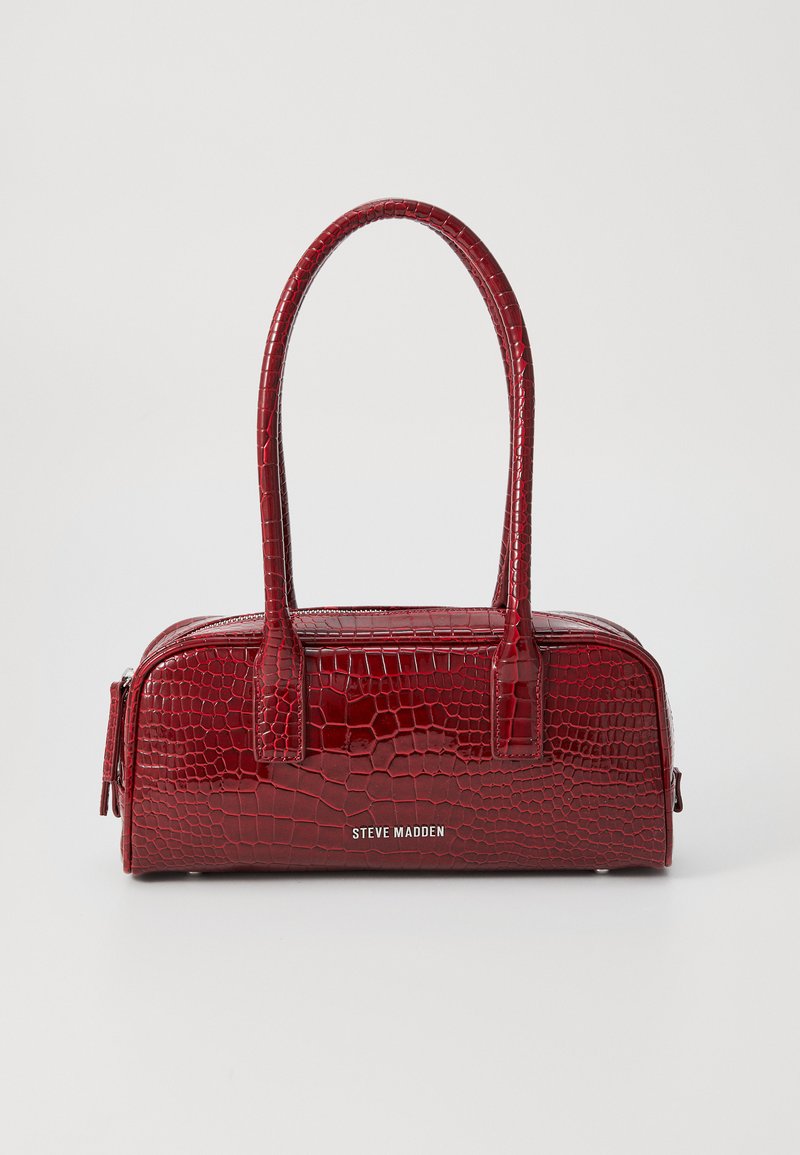 Red crocodile-embossed handbag with two handles, zip closure, and silver hardware. Features a smooth, shiny texture and logo on the front.