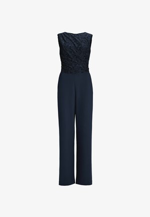 Tuta blu navy con un corpetto in pizzo dal design textured e arricciato, abbinata a pantaloni a gamba larga per una silhouette slanciata.
