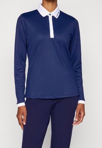 Tmavě modré polokošile s dlouhým rukávem, bílým límečkem, detailem loga, zapínáním na knoflíky, vyrobená z hladké látky. Navržena pro přiléhavý střih.