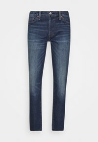 Mörkblå denimjeans med rak bendesign, med knäppning, två framfickor och subtila urtvättning på låren.