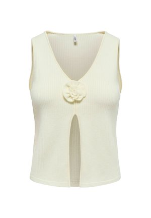 Haut en tricot sans manches de couleur crème avec col en V, fente avant et détail fleur en tissu au centre de la poitrine.