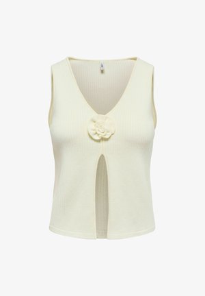 Haut en tricot sans manches de couleur crème avec col en V, fente avant et détail fleur en tissu au centre de la poitrine.