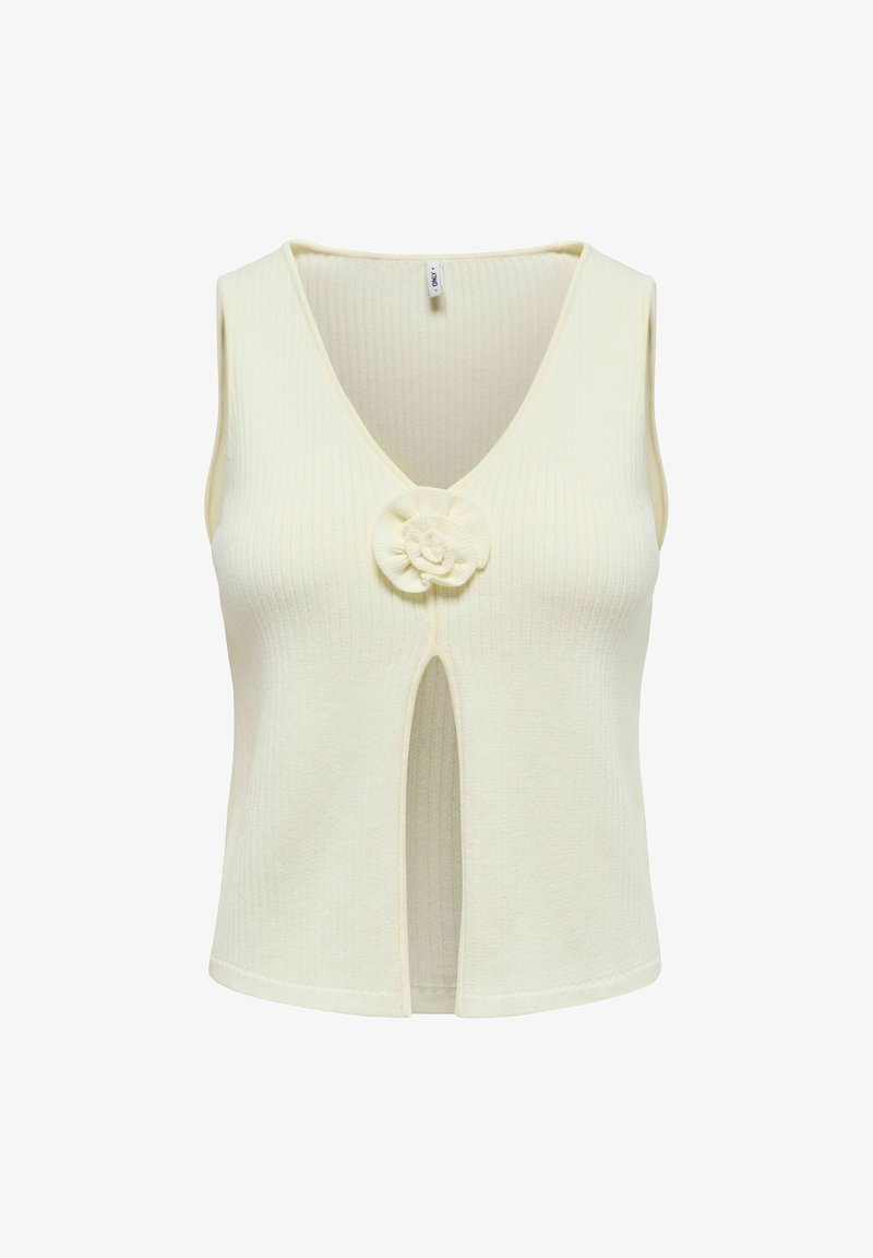 Haut en tricot sans manches de couleur crème avec col en V, fente avant et détail fleur en tissu au centre de la poitrine.