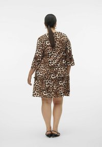 Kjole med leopardprint, trekvartærmer, lagdelt design og flæseaccent. Fremstillet af blødt materiale i jordfarverne brun og creme.
