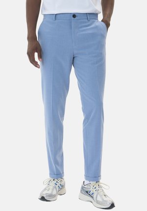 Light blue dress pants with a tailored fit, flat front, side pockets, and ankle cuffs, paired with white sneakers and a white t-shirt.