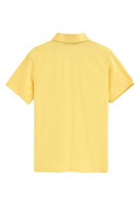 Gul pikétröja, kort ärm, krage, tillverkad av mjukt tyg, med en enfärgad design utan mönster eller dekorationer.