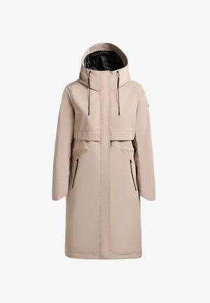 Dlhý béžový zimný kabát s kapucňou, čiernou vnútornou podšívkou, predným zipsom, nastaviteľnými šnúrkami kapucne a bočnými vreckami na zips.