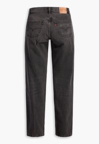 Svarta denimjeans med rak benlinje, fem fickor, sydda detaljer och en tan läderpatch på midjan.