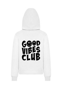 Biela mikina s veľkým čiernym grafickým motívom na chrbte, ktorý znie "DOBRÉ VIBRÁCIE KLUB" s dvoma usmievavými emodži. Mäkká tkanina, štandardný strih.