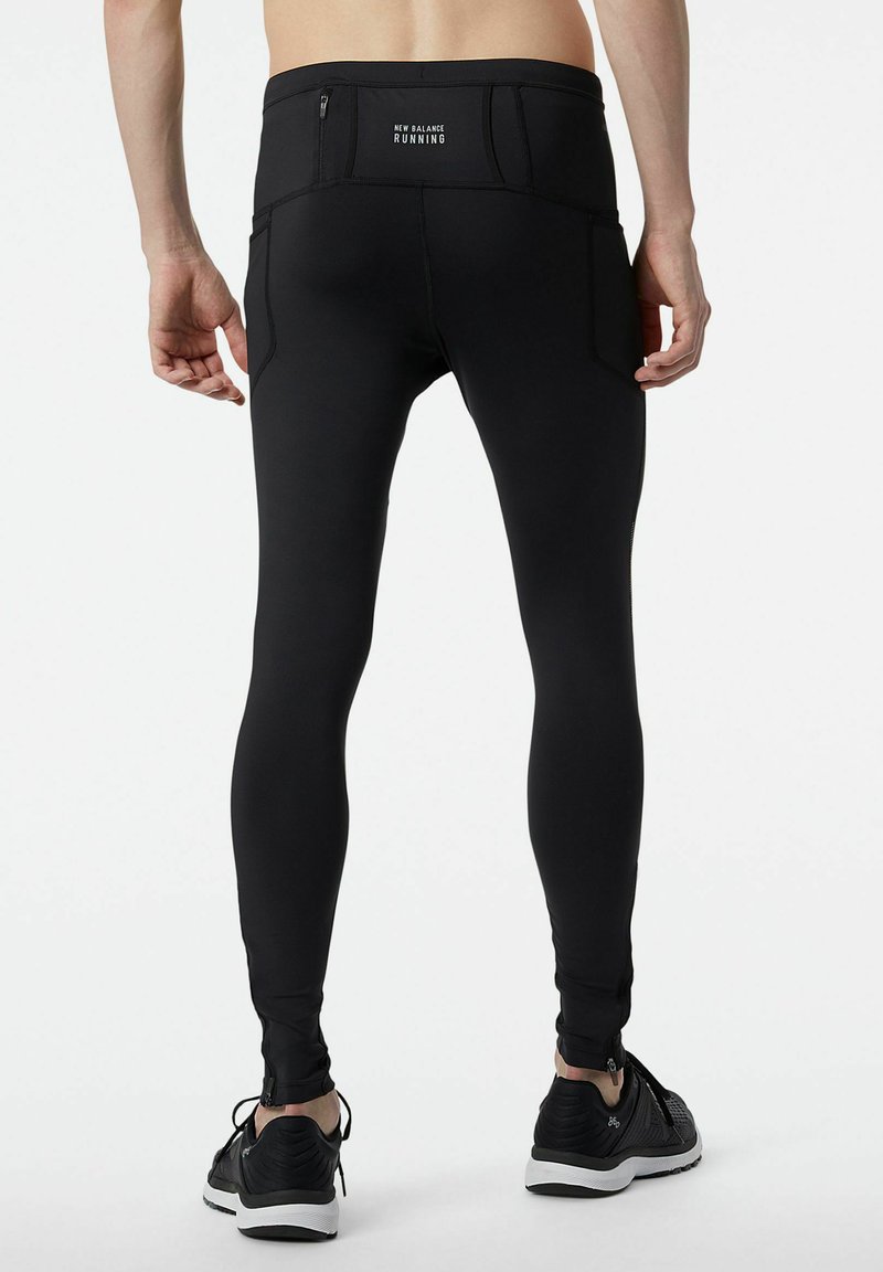 Leggings da corsa neri caratterizzati da un design aderente con una tasca posteriore con zip e tasche laterali, realizzati in materiale elasticizzato e traspirante.