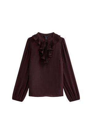 Blouse marron foncé à manches longues avec un col festonné plissé et un détail festonné à l'avant, attaché par de fins cordons au niveau du col.