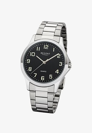 Montre-bracelet en métal argenté avec cadran noir, chiffres arabes blancs, trois aiguilles indiquant 10:10:37, et textes "REGENT" et "QUARTZ".