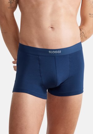 Navy blue boxer shorts made of soft, stretchy fabric. Features a smooth waistband with "SLOGGI" logo and a fitted design for comfort.