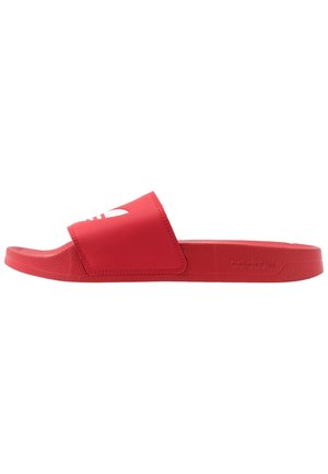 Rote Adidas Slide-Sandale mit breitem Riemen und strukturiertem Profil, seitlich auf weißem Hintergrund dargestellt.