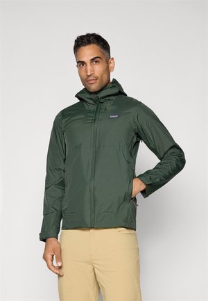 Green waterproof jacket with a hood, featuring a front zipper, side pockets, and a small logo on the chest. Smooth texture, lightweight design.