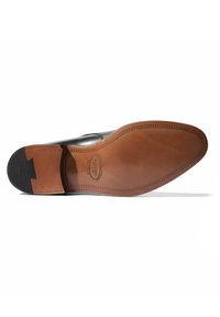 Suela de zapato de cuero con un acabado marrón liso, diseño de costura, tacón de goma negra y logo de marca en relieve.