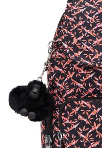 Black fabric backpack with a floral pattern in pink and orange, featuring a furry black gorilla keychain and silver hardware accents.