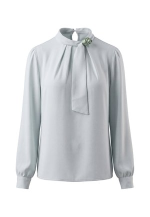 Light gray long-sleeve blouse with high neck, pleats at front, cuffed sleeves, and a decorative bow with rosette on the collar.