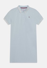 Jasnoniebieska koszulka polo z kołnierzykiem, patką na trzy guziki i paskowanymi mankietami. Posiada małe logo na piersi oraz gładką, bawełnianą fakturę.