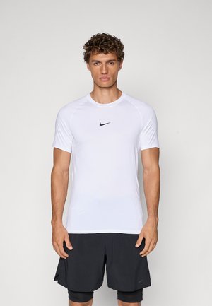 White short-sleeve athletic shirt with a round neckline and black Nike logo on the chest, paired with black shorts, smooth texture.