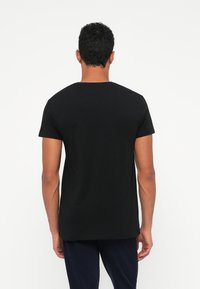 Black short-sleeve t-shirt made from cotton, featuring a crew neck and a simple design, with a smooth texture and no visible patterns.