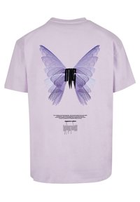 Lilac cotton t-shirt featuring a large purple butterfly graphic on the back, with text below in dark font. Short sleeves and crew neck design.