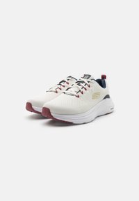 White mesh running shoes with red accents, padded tongue, and cushioned sole. Features black laces and logo on the side. Lightweight design.