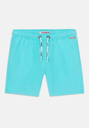 Calções de banho turquesa feitos de um tecido leve. Apresentam uma cintura elástica com cordão ajustável e uma pequena etiqueta de logo na lateral.