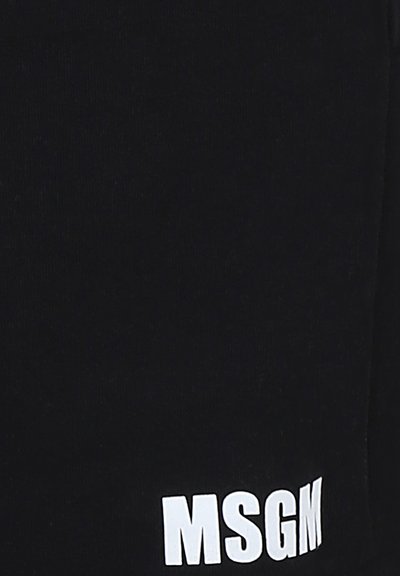 Joggers neri in cotone con una texture a costine e il logo "MSGM" bianco all'orlo. Design semplice, cintura elastica per il comfort.