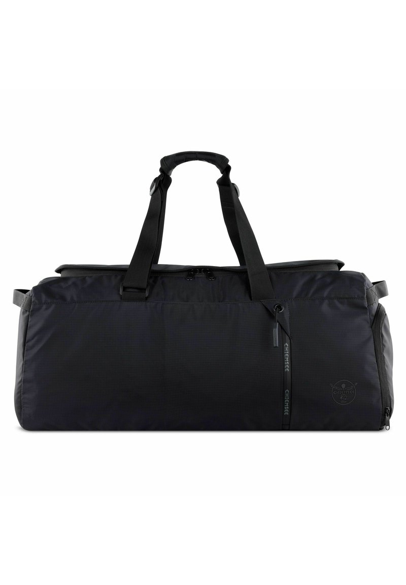 Black duffel bag made of durable fabric. Features two sturdy handles, a zippered top, and a subtle logo detail on the side. Smooth texture.