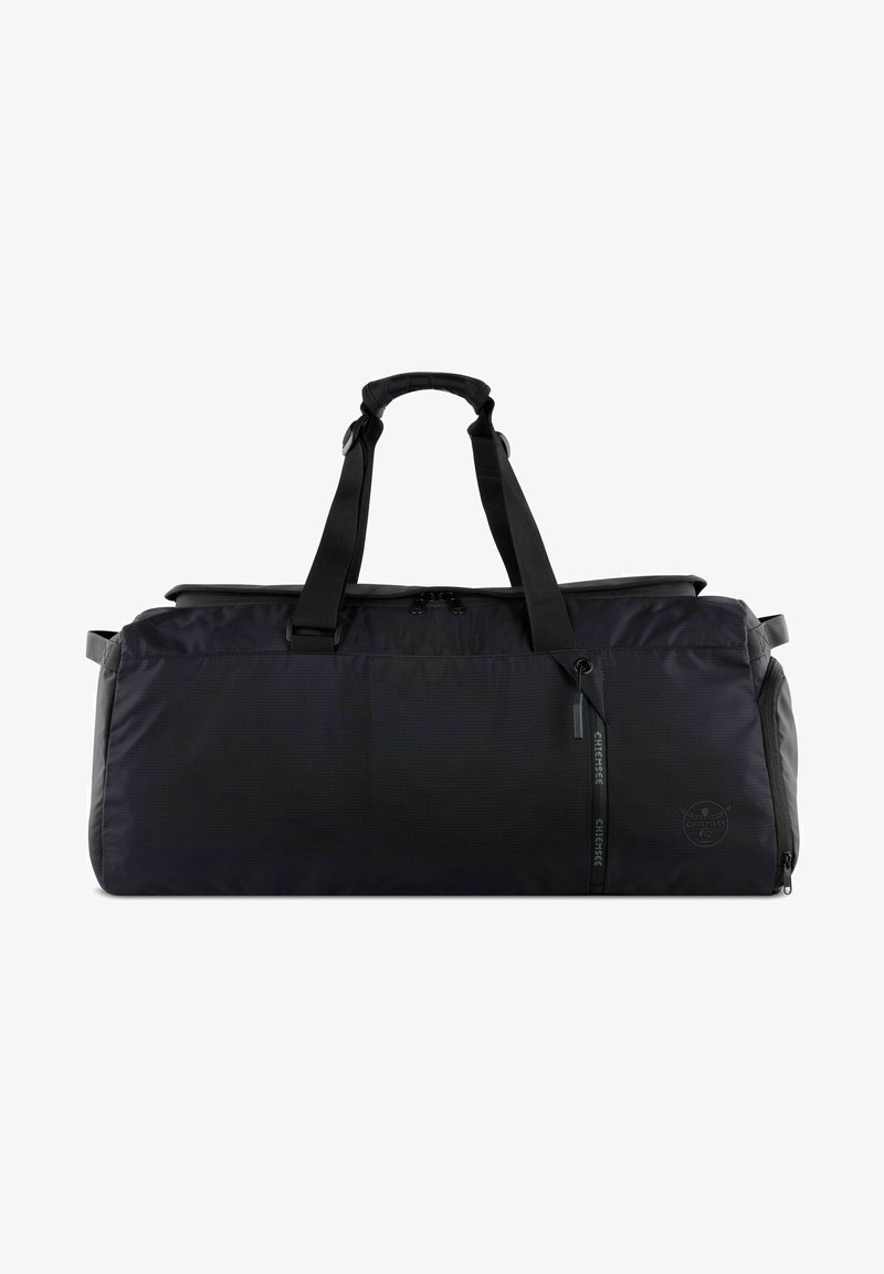Black duffel bag made of durable fabric. Features two sturdy handles, a zippered top, and a subtle logo detail on the side. Smooth texture.