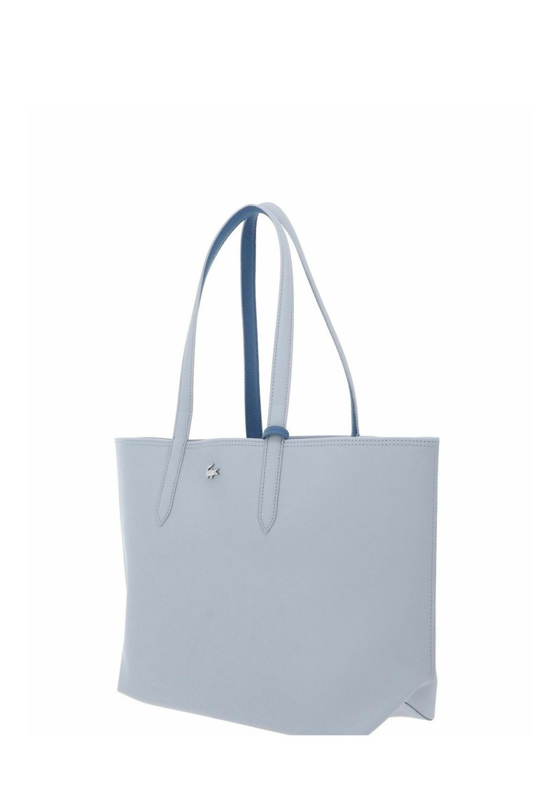 Hellblauer Leder-Shopper mit zwei langen Henkeln und kleinem silbernem Logo auf der Vorderseite, dargestellt vor weißem Hintergrund.