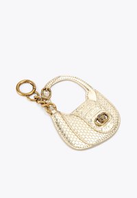 Accessorio portachiavi color oro a forma di borsa, con superficie testurizzata, catena e chiusura decorativa.