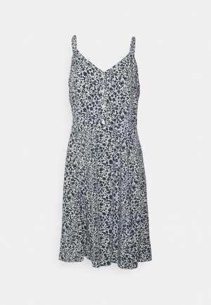 Robe sans manches bleu marine et blanche à motifs floraux avec des boutons sur le devant et de fines bretelles.