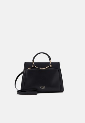 Black structured handbag with gold circular handle, front zipper pocket, and detachable shoulder strap, branded LYDC London.