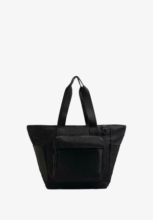 Black tote bag made of soft material, featuring wide straps, a large main compartment, and a front zip pocket. Boxy shape with textured finish.