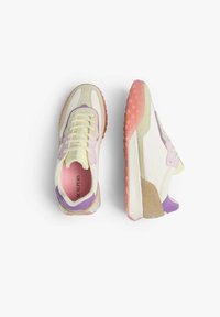 Multicolored sneakers featuring a mix of cream, lavender, and pink hues. Soft suede and rubber soles with a textured grip design.