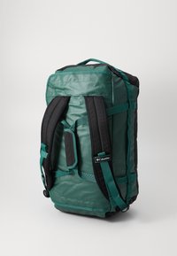 Green and black duffel bag with padded shoulder straps, sturdy zippers, and a smooth, textured surface. Features Columbia logo and adjustable straps.