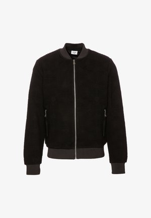 Black bomber jacket with textured fabric, ribbed collar and cuffs, silver zipper, and two side zippered pockets.