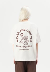 White cotton t-shirt with a relaxed fit featuring brown graphic text and an illustration of a wave character on the back.