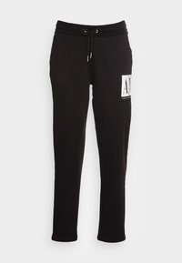 Svart slim-fit sweatpants med elastisk midjeband, dragsko och vit rektangulär Armani Exchange-logga på övre vänstra l år.