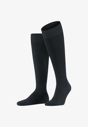 Calze nere al ginocchio con bordo a costine, texture liscia e punta rinforzata; progettate per comfort e supporto.