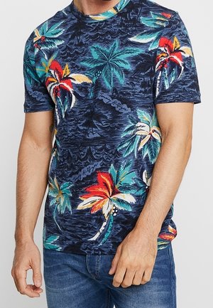T-shirt à manches courtes de couleur marine avec un imprimé tropical de palmiers aux couleurs vives, doté d'une texture douce et d'un col rond classique.