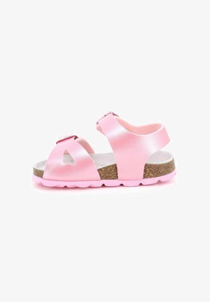 Sandalo rosa per bambini con due cinturini regolabili, soletta in sughero e suola in gomma rosa su sfondo bianco.