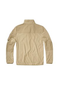 Beige Fleecejacke mit hohem Kragen, langen Ärmeln und verstärkten Schulterpatches; verfügt über eine Seitentasche am linken Ärmel. Glatte Textur.