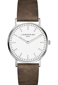Analogischer Armbanduhr mit weißem Zifferblatt, silbernem Gehäuse, braunem Lederarmband, dünnen Stundenmarkierungen und minimalistischem Design. Markenname: LIEBESKIND.